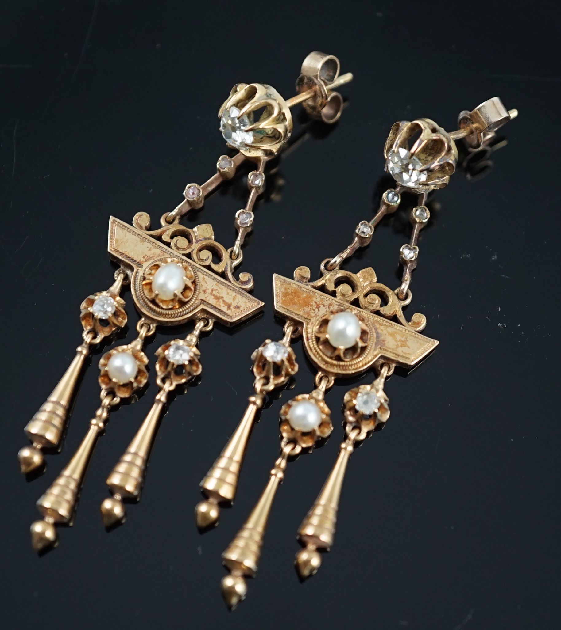 A pair of Victorian gold, seven stone diamond and two stone pearl set triple drop earrings, of aesthetic design